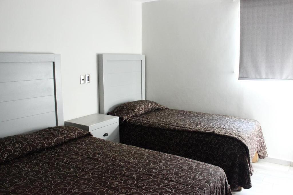 Postel nebo postele na pokoji v ubytování Hotel Colon Express