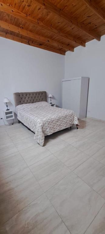 a bedroom with a bed and a wooden ceiling at Apartment for 2 people - Erezcano two in Adrogué