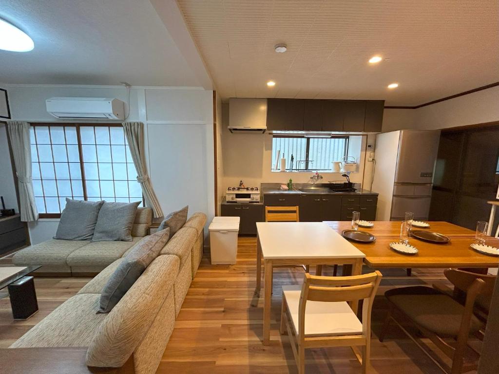 a living room with a couch and a table at 徳島市のまるごと貸切一軒家 最大5名 無料駐車場2台 in Tokushima
