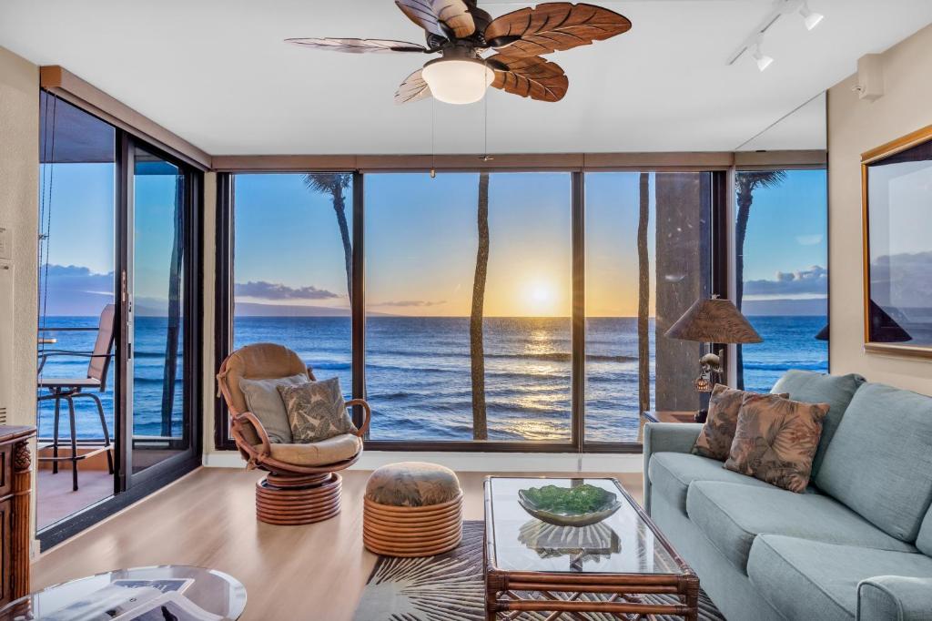 a living room with a view of the ocean at Mahana 305 in Kahana