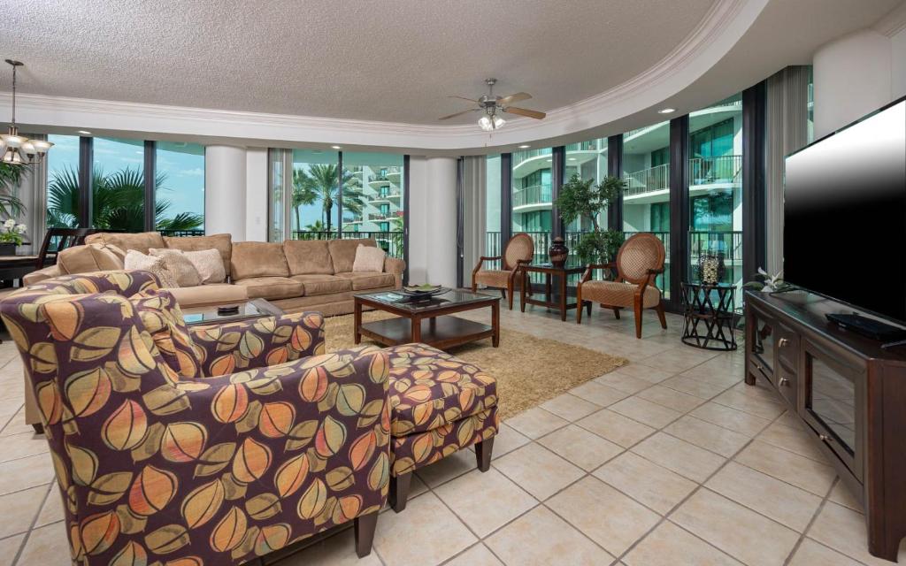 a living room with a couch and a flat screen tv at Lighthouse on the Bay 2311 condo in Orange Beach