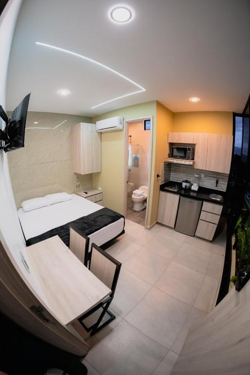 Una pequeña habitación con una cama y una cocina. en Experience Medellín's Comuna 13 INT401, en Medellín