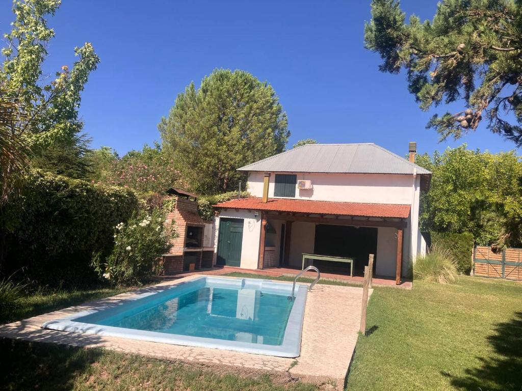 a house with a swimming pool in the yard at Granero Chacras in Ciudad Lujan de Cuyo
