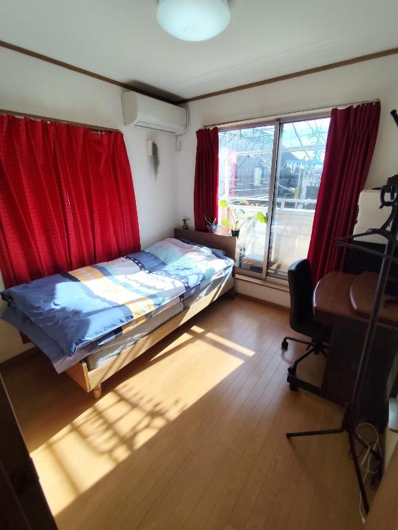 Postel nebo postele na pokoji v ubytování 関東最大のスパが身近にあり