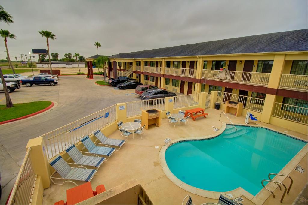 an aerial view of a hotel with a swimming pool at Deluxe Inn and Suites in Raymondville