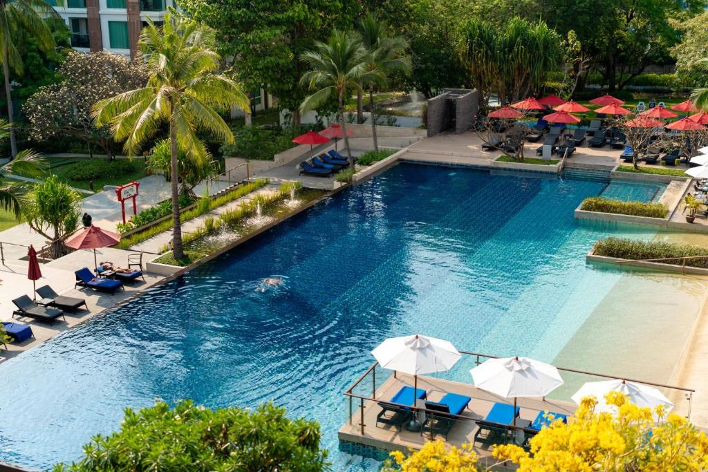 an overhead view of a swimming pool with umbrellas at Amari Hua Hin in Hua Hin
