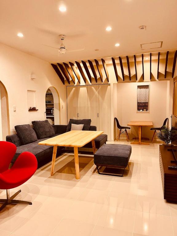 a living room with a couch and a table at ヴィラパーム in Miyako-jima