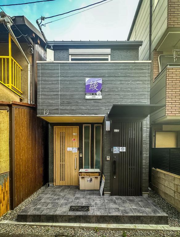 a building with a bike sign in front of it at 花渓居 绫 in Osaka