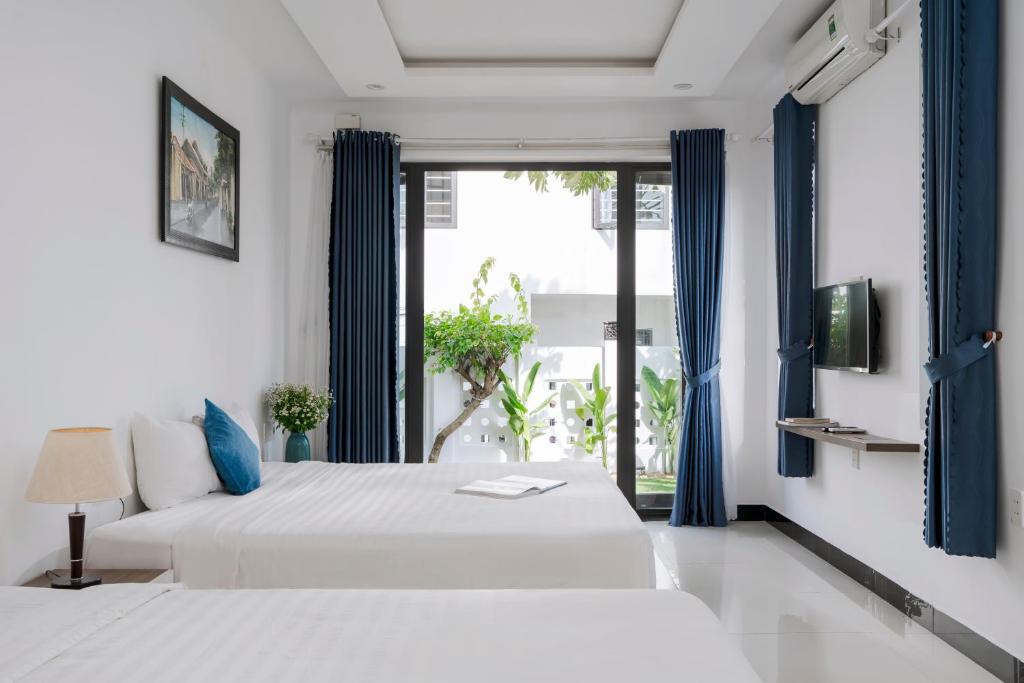 Giường trong phòng chung tại Sunora Villa Hoi An