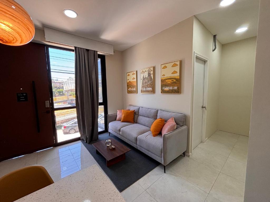 a living room with a couch and a large window at Apartment in the heart of SA in Santa Ana