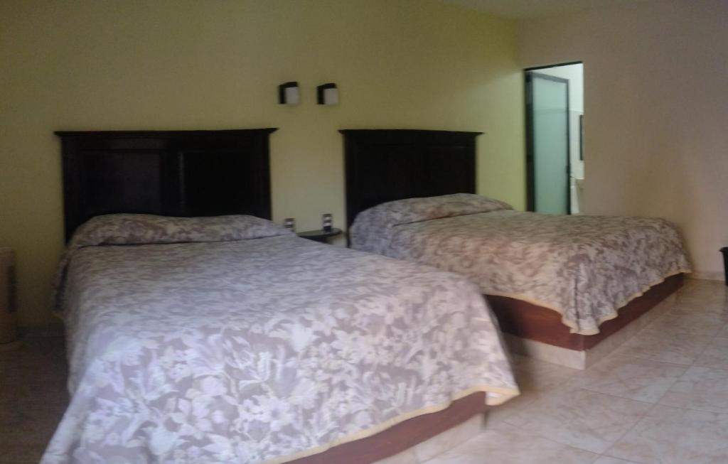 Postel nebo postele na pokoji v ubytování Hotel El Refugio