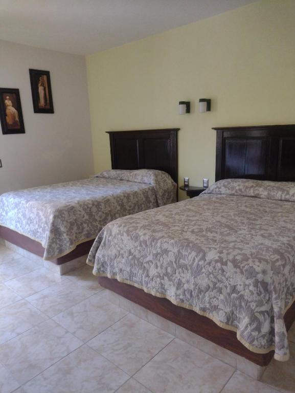 Postel nebo postele na pokoji v ubytování Hotel El Refugio