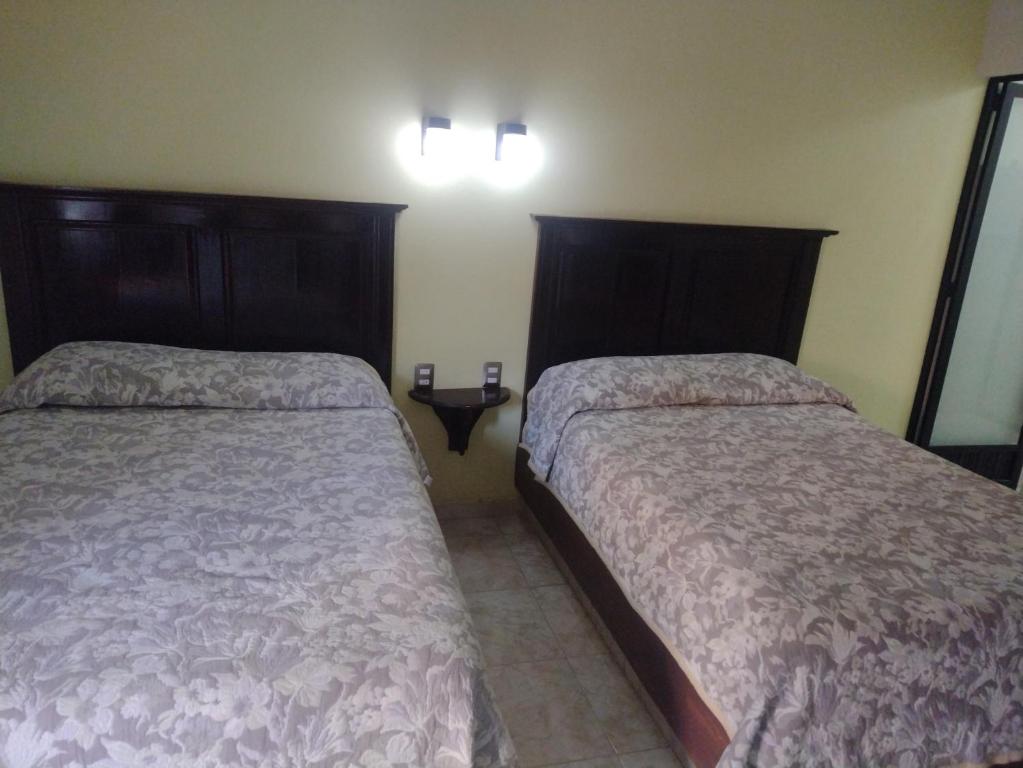 Postel nebo postele na pokoji v ubytování Hotel El Refugio