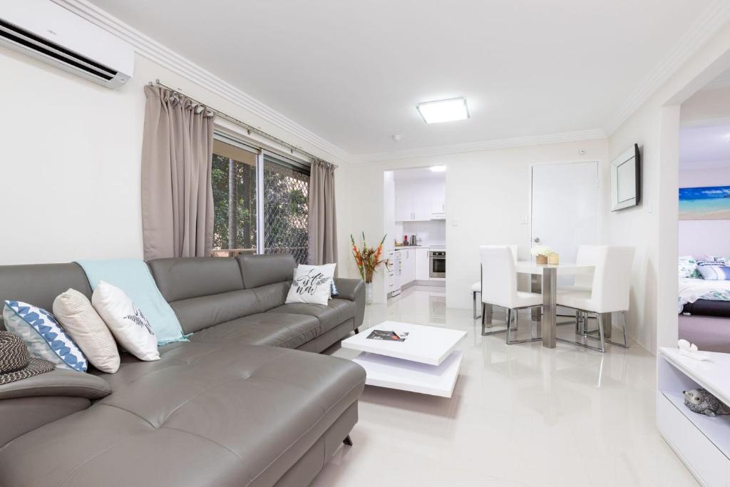 a living room with a couch and a table at Anchorage 31 in Tuncurry