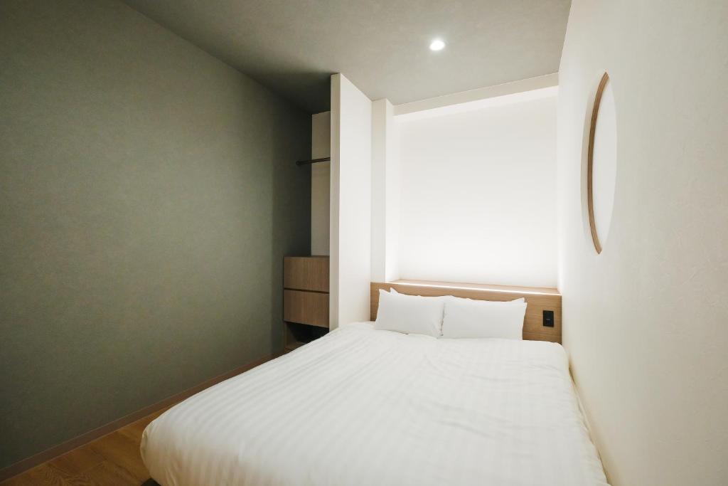 Ένα ή περισσότερα κρεβάτια σε δωμάτιο στο HOTEL ALL IN Kumamoto