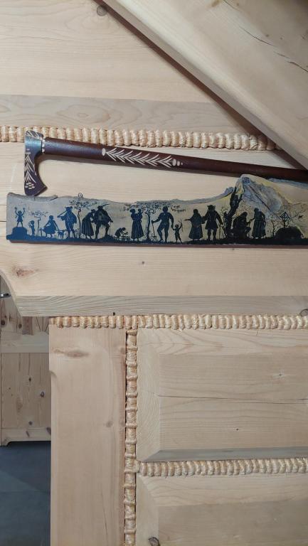 a painting of horses on the side of a bed at BIAŁY PUCH in Zakopane
