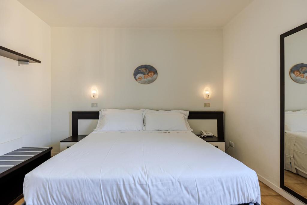 Postel nebo postele na pokoji v ubytování Hotel Alla Torre