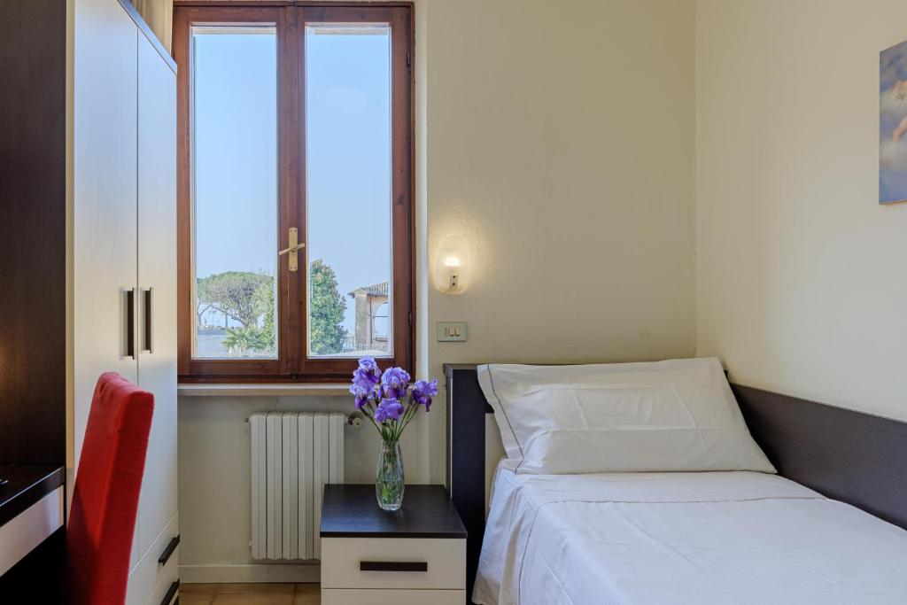 Postel nebo postele na pokoji v ubytování Hotel Alla Torre