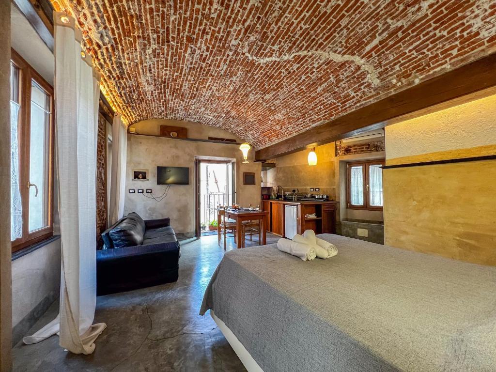 a bedroom with a large bed with a brick ceiling at lovingenoa Light - Passion in Genoa