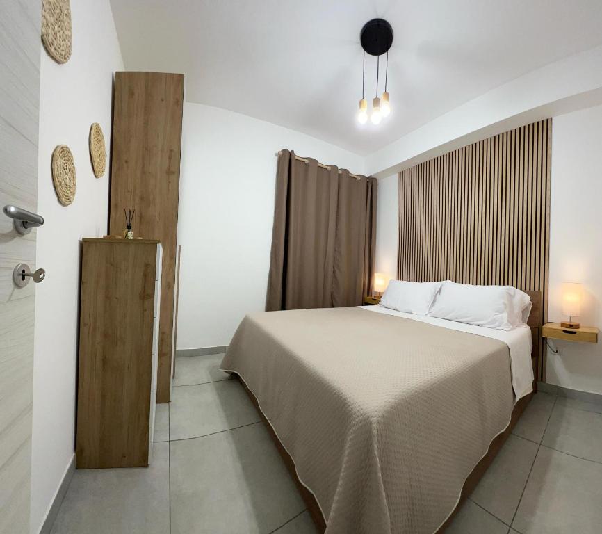 a bedroom with a large bed in a room at Le Voyage Holiday Home Marzamemi in Marzamemi