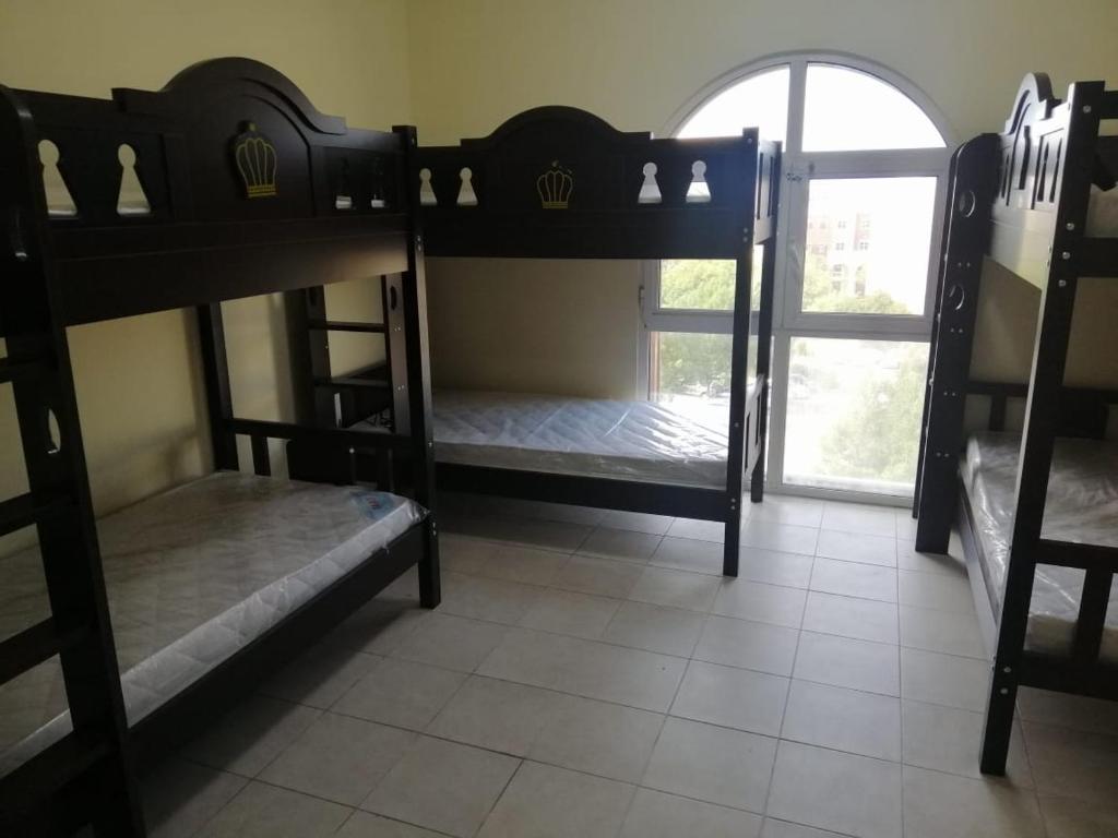 two bunk beds in a room with a window at The Gardens home in Dubai