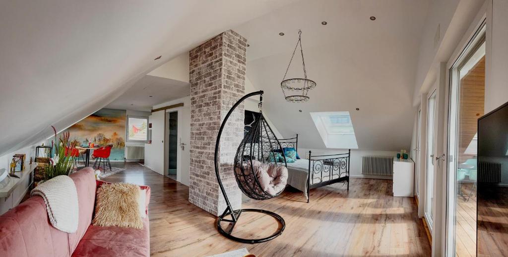 a living room with a couch and a crib at Studio Dinkelberg in Adelhausen