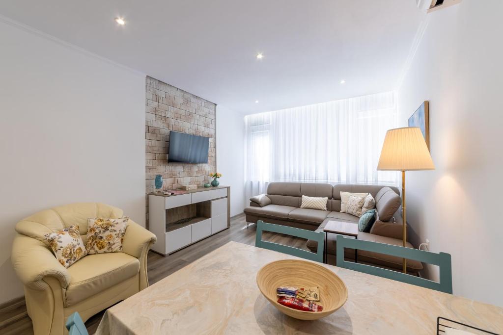 a living room with a couch and a table at E-home Apartments in Varna City