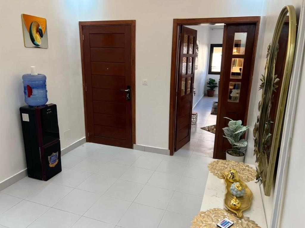 a room with a hallway with a refrigerator and a door at Appartement mariste près de auchan in Darou Rhamane