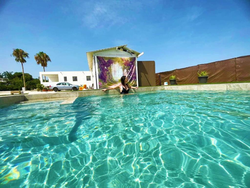 a woman is standing in a swimming pool at Finca Laxuan in Cádiz