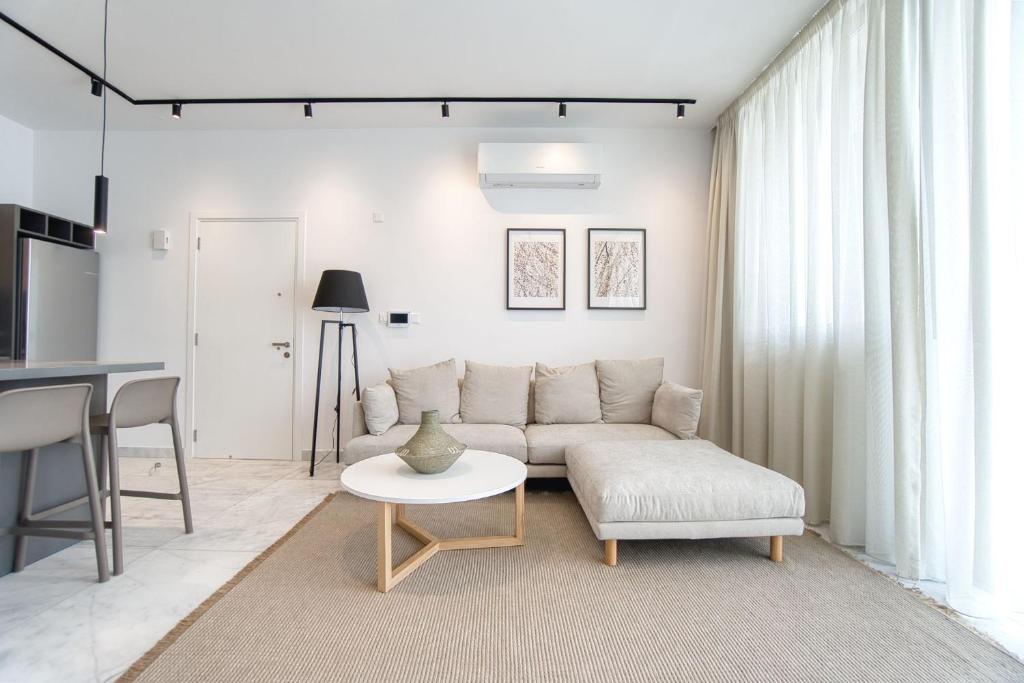 a living room with a couch and a table at Prestige 401 2 BED in Paphos