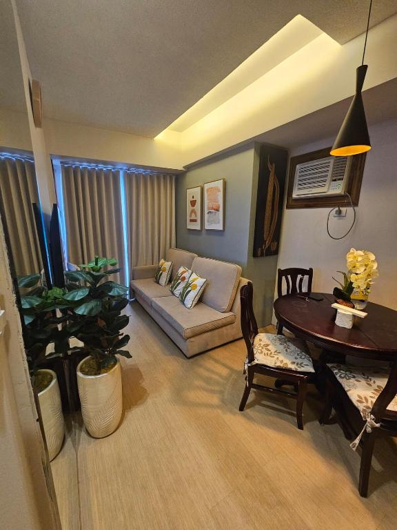 a living room with a couch and a table at Steff's Condo 1708 one bedroom in Cagayan de Oro