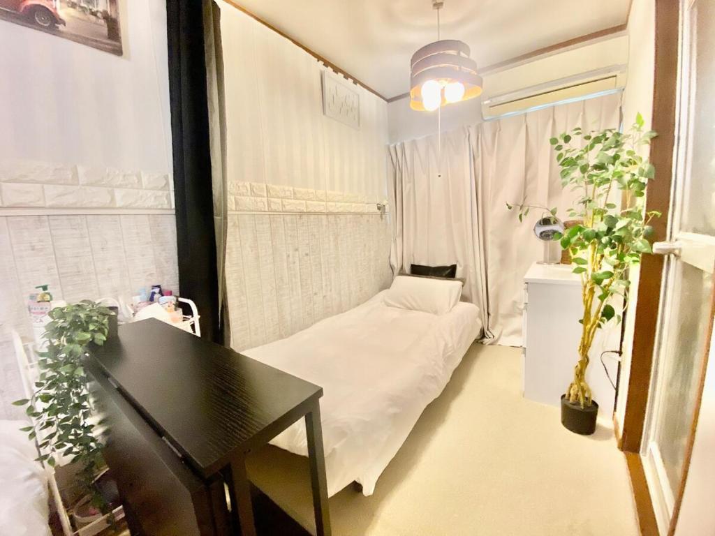 Cama ou camas em um quarto em Momodani 72 two-story detached house