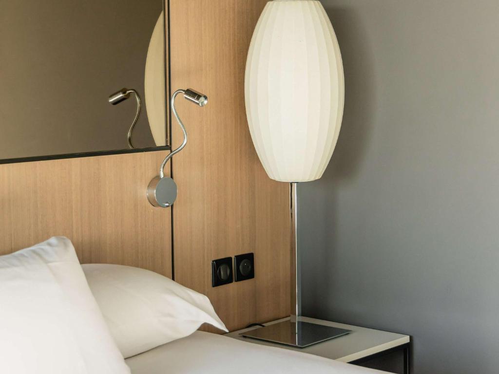Postel nebo postele na pokoji v ubytování Pullman Bordeaux Lac