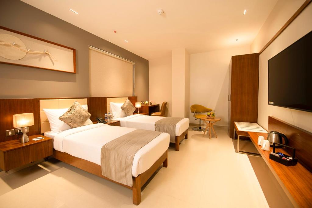 Postel nebo postele na pokoji v ubytování Morvee Hotels Durgapur
