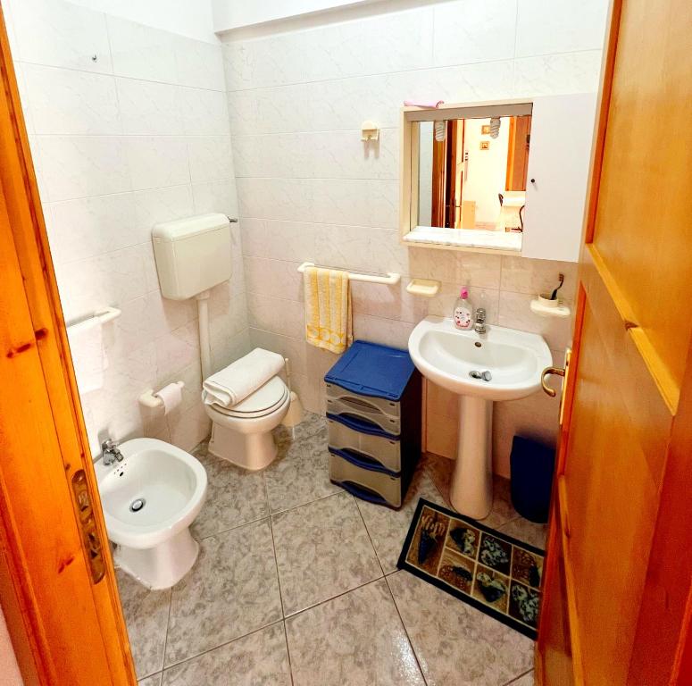a bathroom with a toilet and a sink at Bentu e Soli Home Holiday in Villasimius