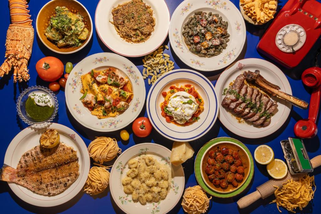 a table with many plates of food on it at Beach Walk Boutique Jumeirah in Dubai