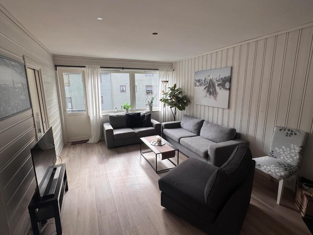 a living room with a couch and a chair at Apart, 4 pers, Central in Odda in Odda