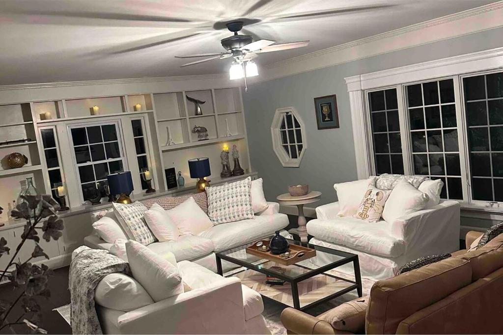 a living room with white couches and a ceiling fan at Luxury Estate Elegant Private The White Lion Manor in Middletown