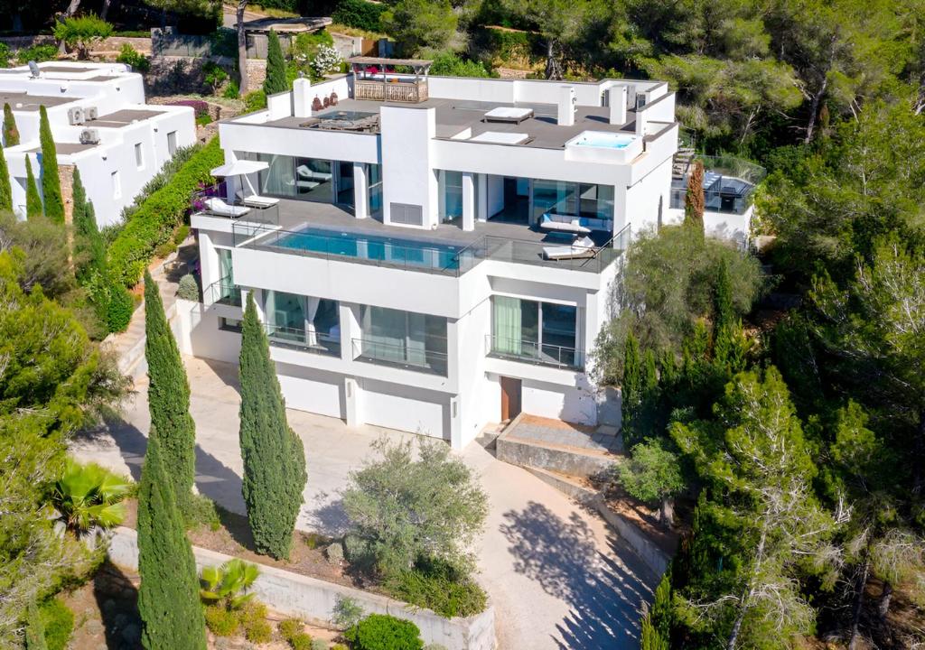 an aerial view of a white house with trees at La Perla de Ibiza in Santa Eularia des Riu