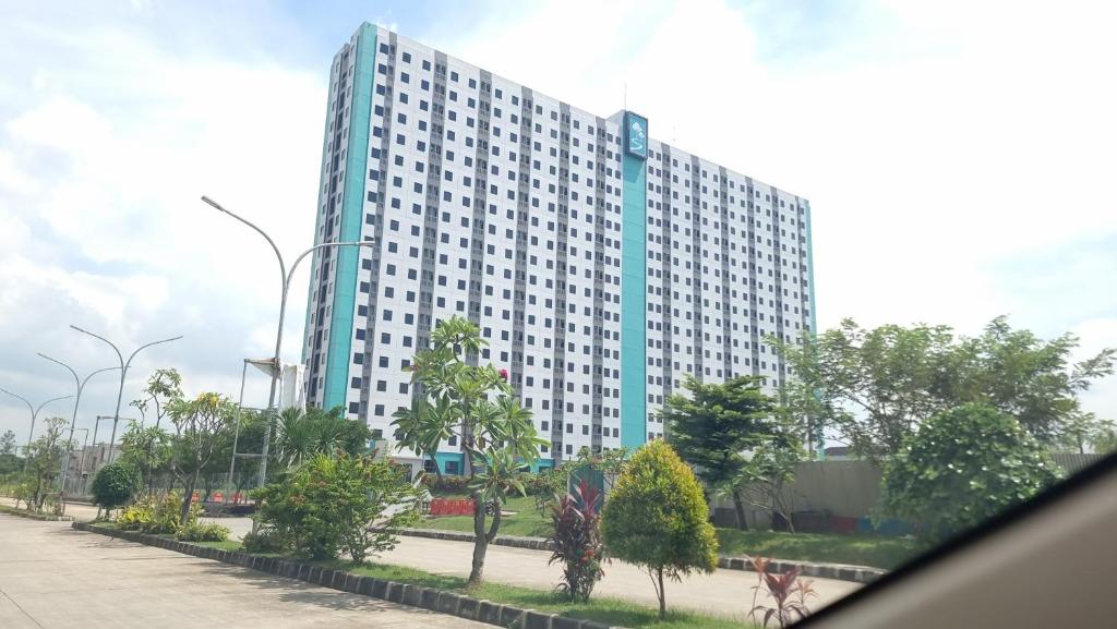 a large white building with a road in front of it at Dancenter Bekasi Formerly Riverdale in Tanahbaru