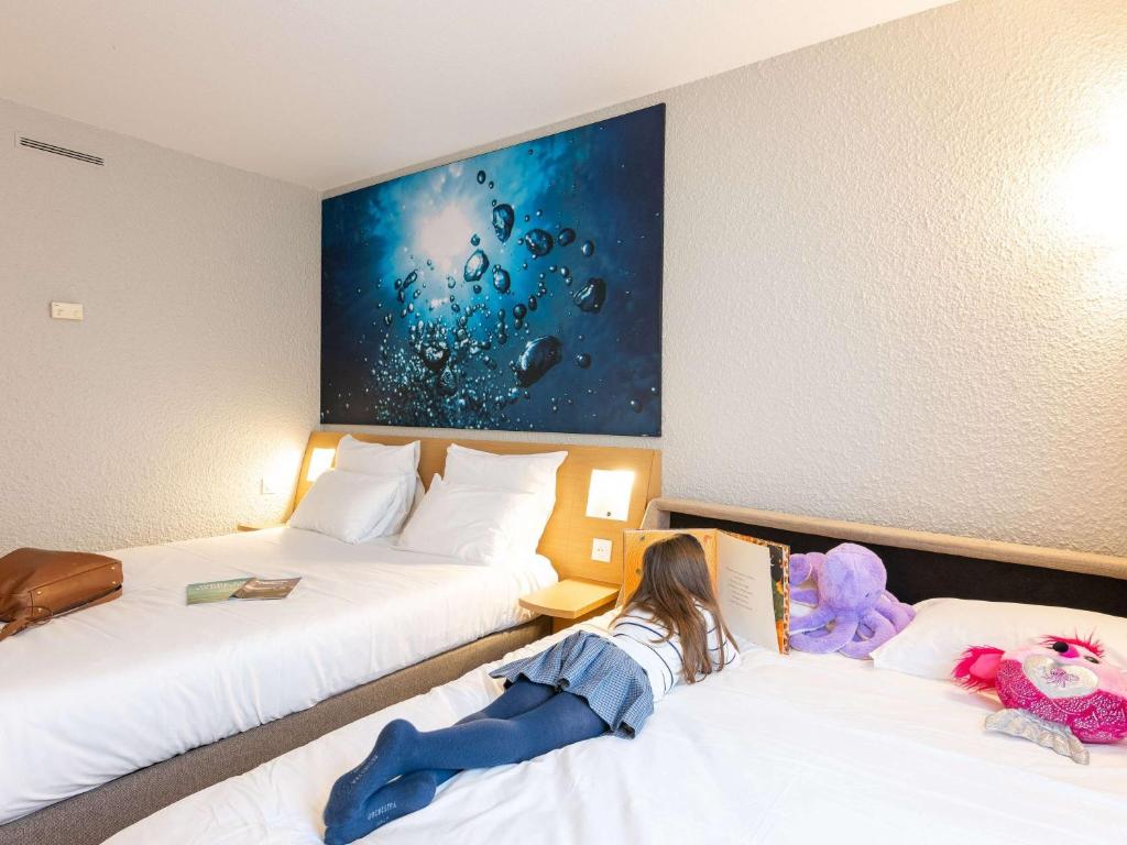 Postel nebo postele na pokoji v ubytování Novotel Grenoble Nord Voreppe