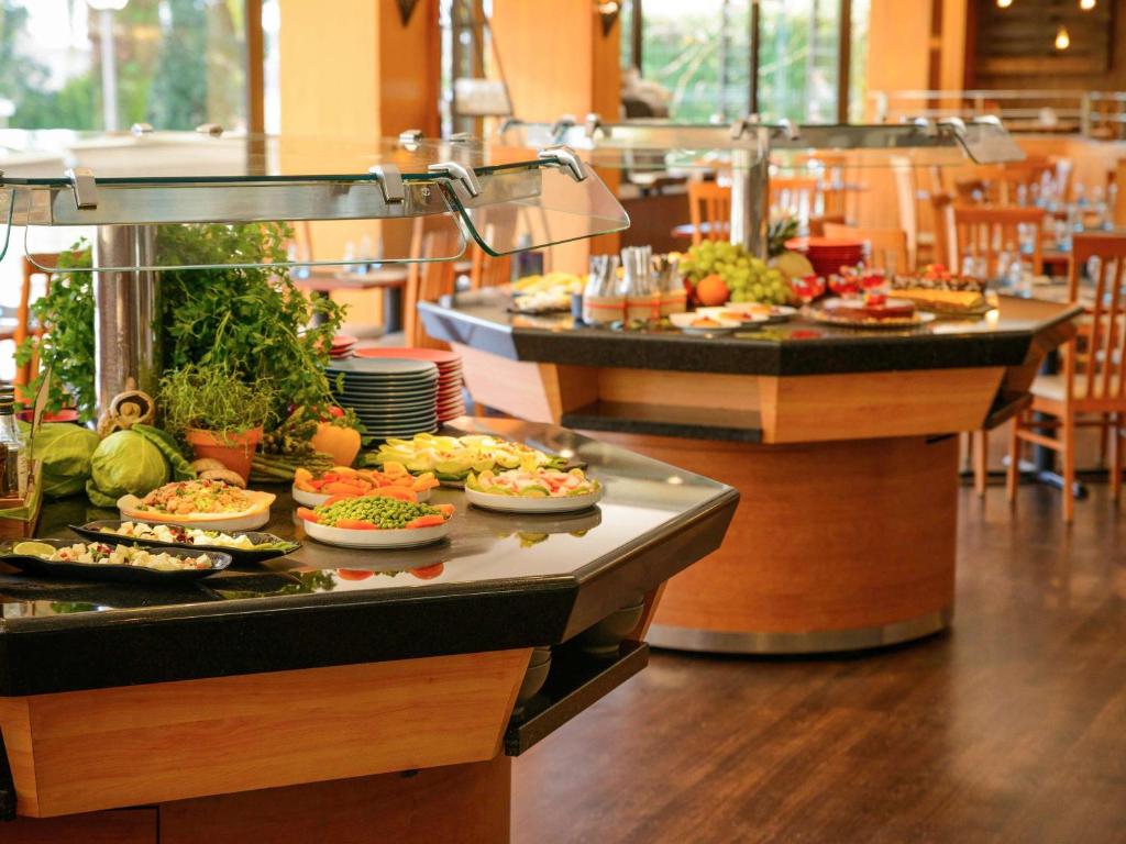 a buffet line with many different types of food at Novotel Porto Gaia in Vila Nova de Gaia