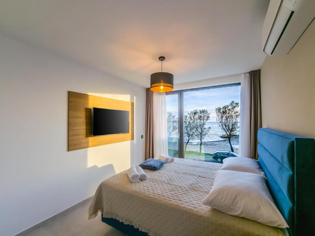 Postel nebo postele na pokoji v ubytování Sunrise Beachfront Residence