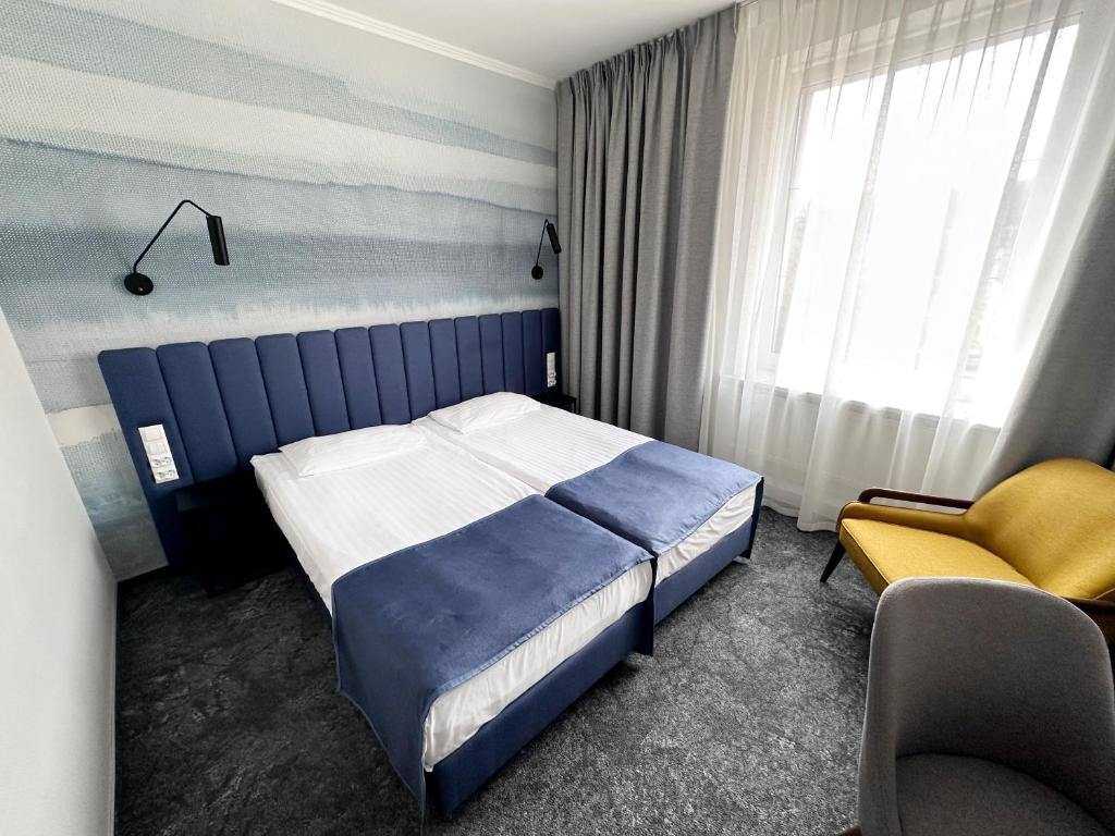 Posteľ alebo postele v izbe v ubytovaní Hotel Szydłowski
