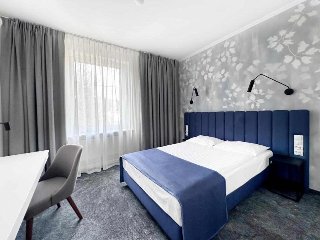 Posteľ alebo postele v izbe v ubytovaní Hotel Szydłowski