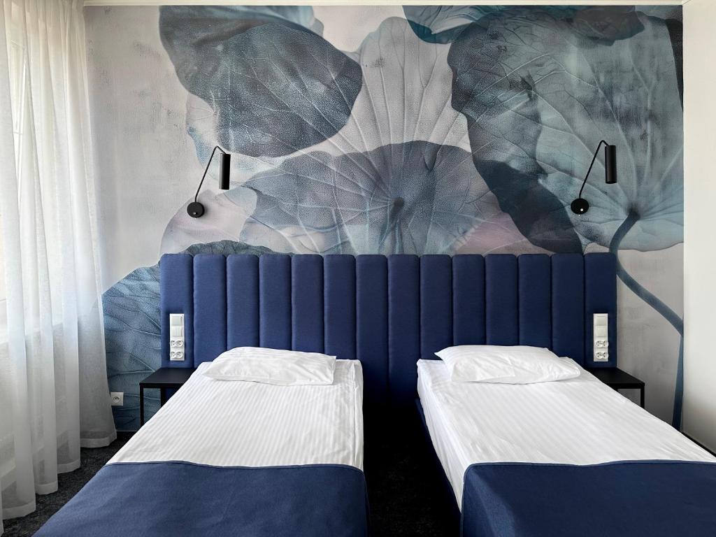 Posteľ alebo postele v izbe v ubytovaní Hotel Szydłowski