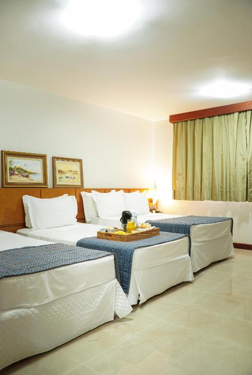 Postel nebo postele na pokoji v ubytování Copas Executive Hotel