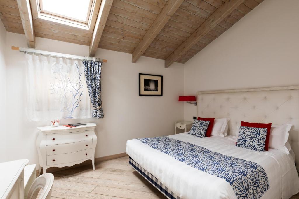 a bedroom with a bed and a window at La Ciliegina Lifestyle Hotel in Naples