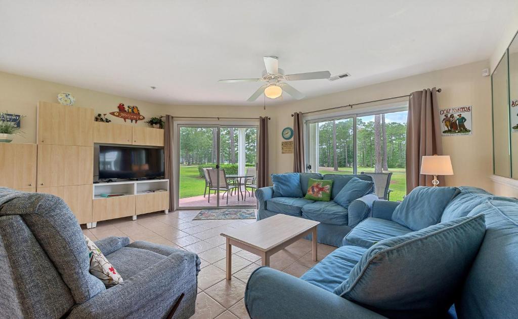 a living room with two blue couches and a tv at Relax, Beach, Golf, Shop, Repeat resort in Calabash