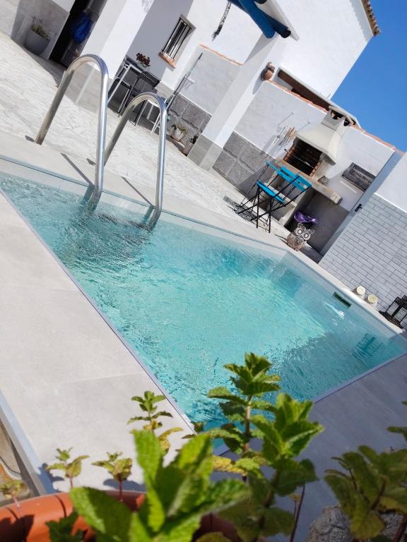 a swimming pool in the middle of a house at La magia del sur in Vejer de la Frontera